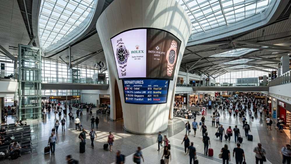 Strategic integration of Rolling LED screens on architectural columns in a modern airport terminal.
