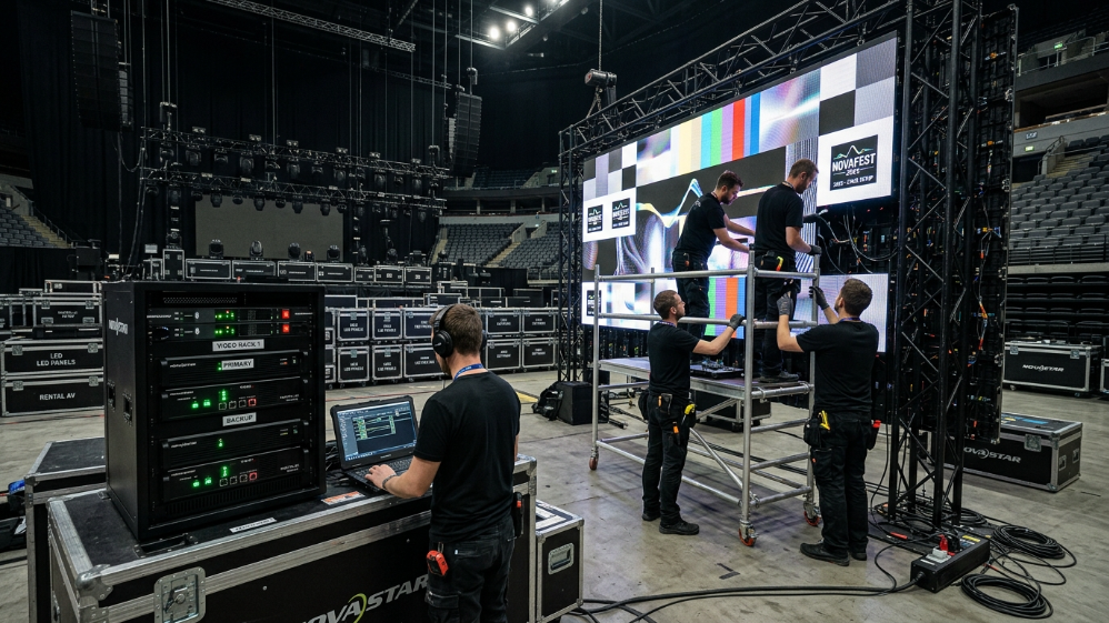 Technicians installing a modular LED video wall for a concert stage